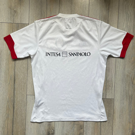 AC Milan x Dolce & Gabbana 2009/10 Training Tee is a white football shirt with red ended short sleeves. The chest features AC Milan and Adidas logos on the sides, and a D&G Dolce & Gabbana Junior logo in the center. Made with Climalite technology, it is designed for performance wear.