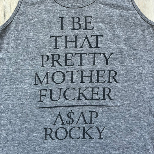 A$AP Rocky 2012 “Peso” Gray Tank Top is a grey sleeveless shirt sold at concerts during the early A$AP Rocky tours. The front features stacked text reading “I be that pretty mother fucker” arranged word-by-word from top to bottom, followed by a line and “ASAP Rocky” beneath. The neckline includes A$AP Rocky branding printed on the tag area.