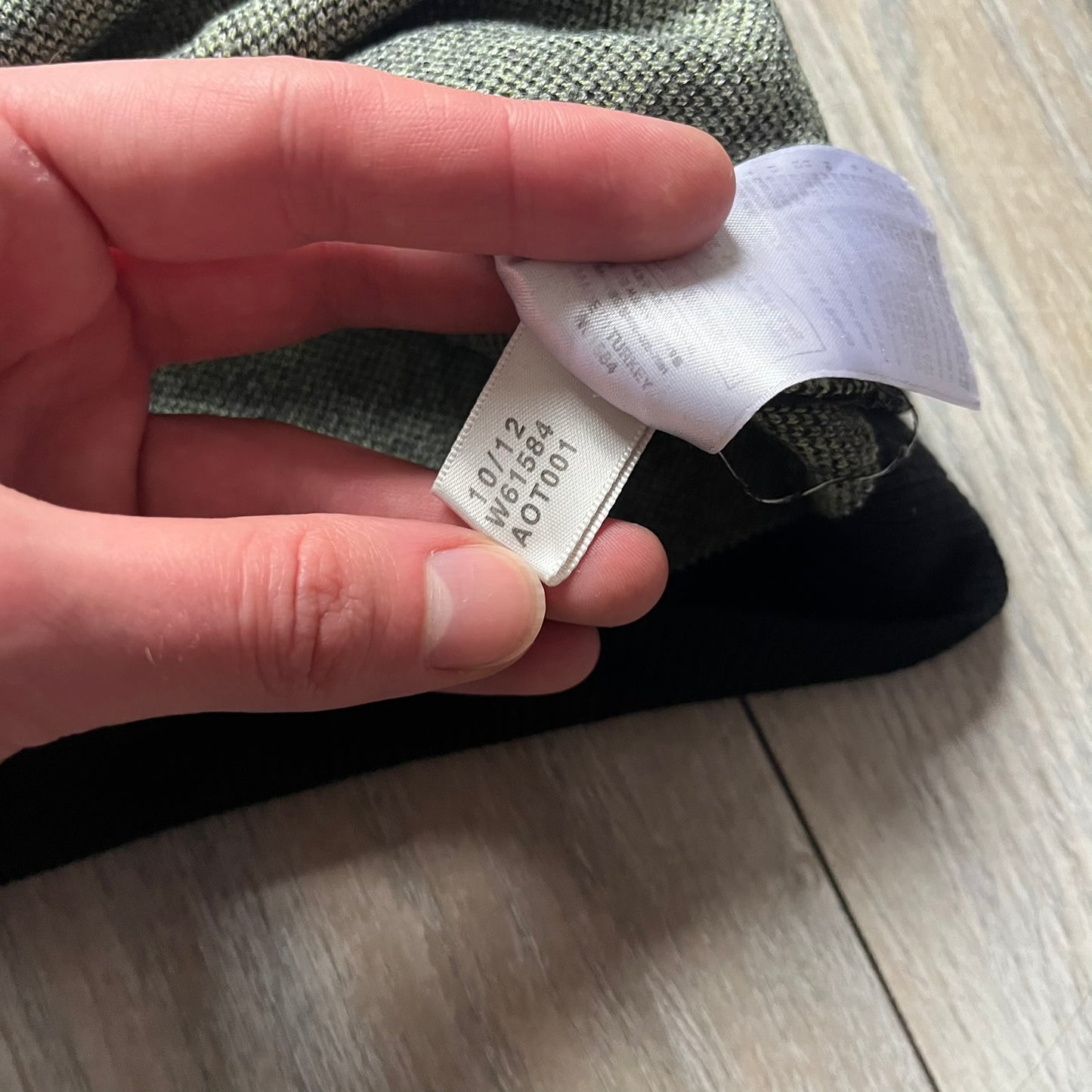 Adidas Jeremy Scott Alien Face 2012 Sweater features an all-over print of white alien faces arranged in alternating upright and upside-down patterns. The eyes of each alien are replaced with green Adidas Originals logos, creating a distinctive graphic design.