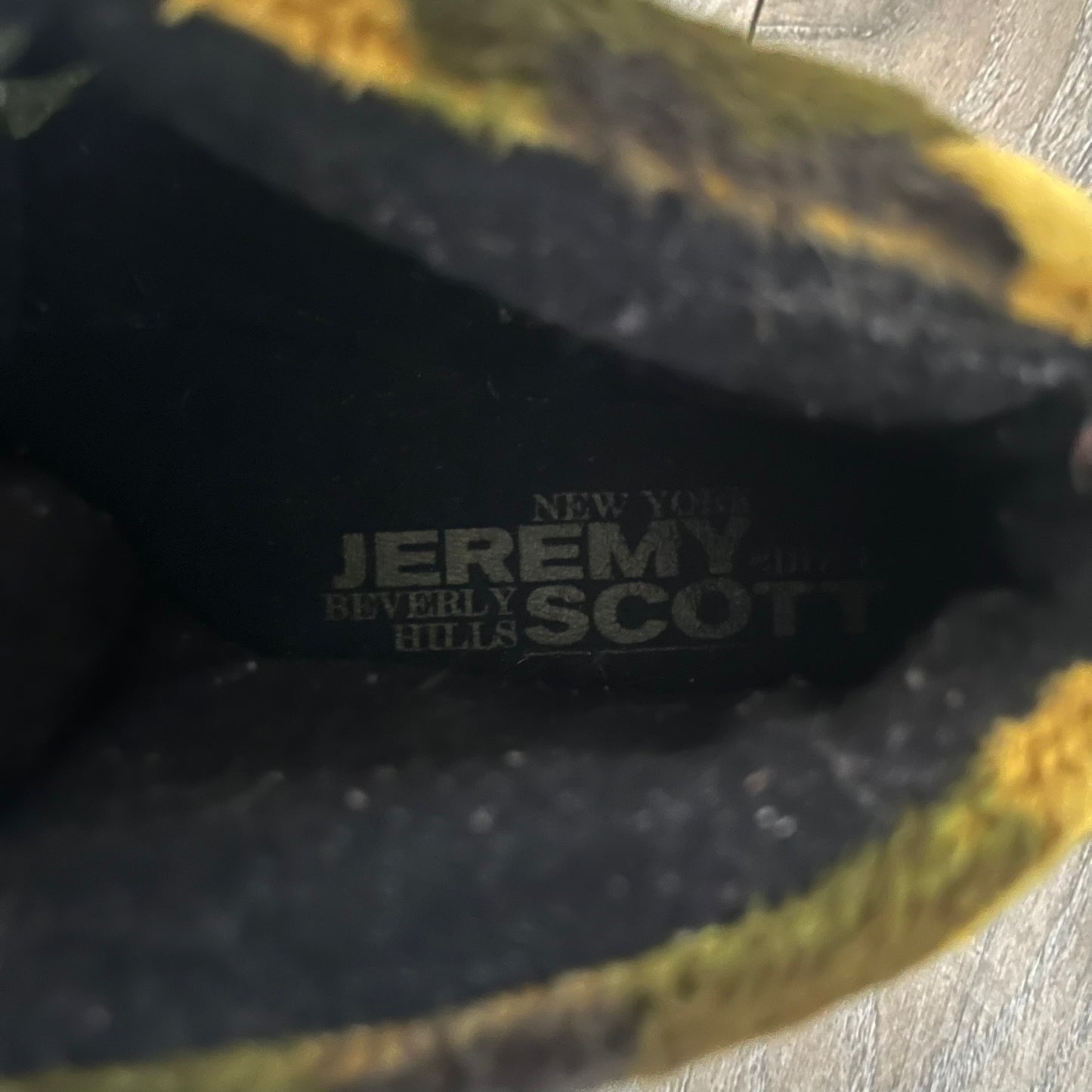 Adidas Jeremy Scott “Camo Bear” Sneakers (Style Q20917) released on March 16, 2013, in Earth Green/Black/Shioli. Featuring plush fleece uppers with a camouflage pattern, black three stripes, and a fully stuffed teddy bear head and arms on the tongue. Includes Jeremy Scott signature detailing on the inside heel and a black rubber sole.