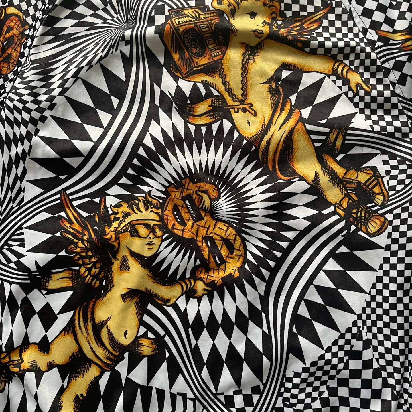 Gold cherub figures and dollar signs on a black and white patterned background