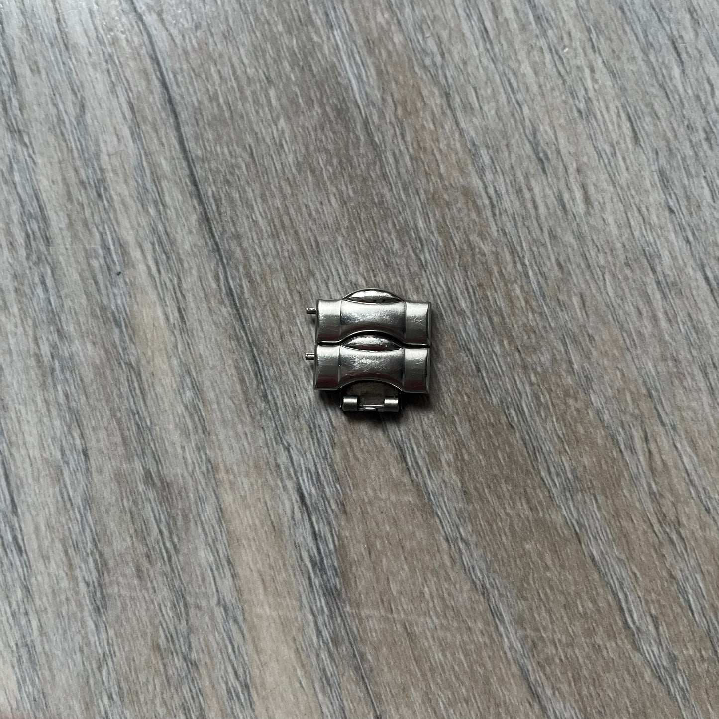 Adidas VS Chronograph 10-5010 Analog Watch is a silver-tone metal timepiece featuring a metallic blue dial with day and seconds indicators. The watch includes three sub-dials, a detailed seconds track, and three side buttons for chronograph functions. Designed with a sturdy, thick case, it comes with an extra link for adjustable sizing.