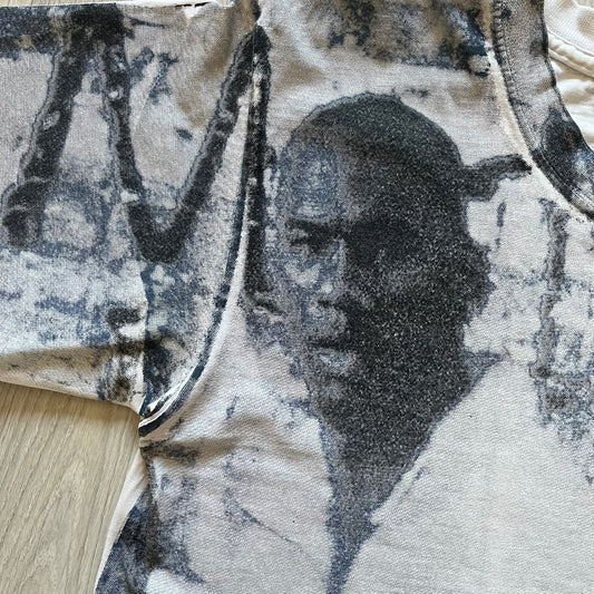 Air Jordan 2000’s All Over Print Tee featuring a bold full print of Michael Jordan in black, white, and blue across the front. A small red Jumpman logo sits at the bottom, while the back showcases a large Air Jordan logo with embroidered small red logo just under the collar. A rare vintage piece from the 2000s that captures peak Jordan era style.