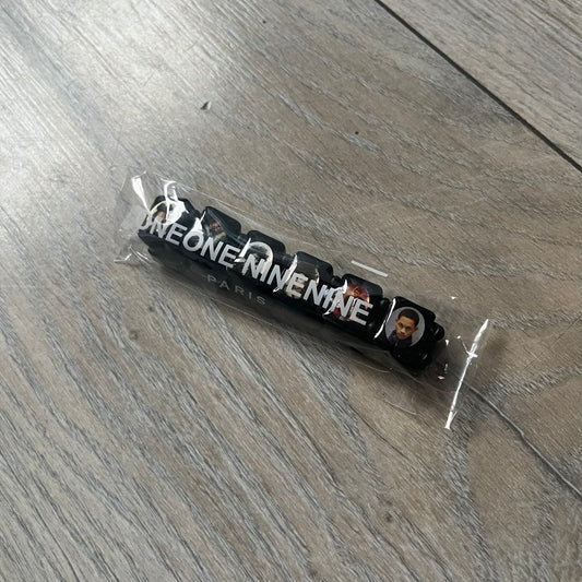 Black “Forever 27 Club” bracelet by Bazo 1199, showcasing painted wooden beads and engraved portraits of legendary artists from the infamous 27 Club like Kurt Cobain, Basquiat, and Fredo Santana. Signed “forever 27 club” and “1199” on the inside.