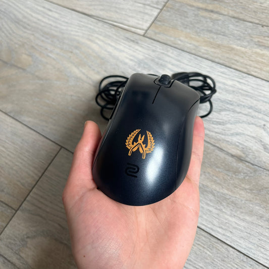BenQ Zowie EC1-B CS:GO Special Edition Gaming Mouse is a wired ergonomic mouse designed for right-handed users, featuring a PixArt 3360 optical sensor with adjustable DPI settings. The black casing includes a CS:GO Guardian graphic, with a 1000 Hz polling rate, five buttons, and a scroll wheel for precise control. It has a USB connection, 2-meter cable, and a lightweight 94 g construction optimized for palm and claw grip styles.