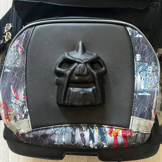 Rare 2007 Bionicle Inika "Toa Nuparu" school backpack made by Grown Up Licenses Limited under The Lego Group. Features a 3D molded Toa Nuparu head on the lower front pocket and a fully printed velcro top compartment with Bionicle figures. Spacious, durable, and reinforced for structure. A standout collectible for any true Bionicle fan.
