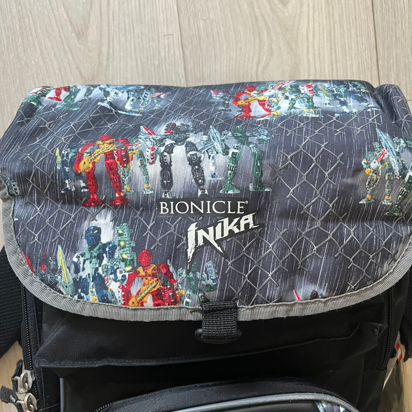 Rare 2007 Bionicle Inika "Toa Nuparu" school backpack made by Grown Up Licenses Limited under The Lego Group. Features a 3D molded Toa Nuparu head on the lower front pocket and a fully printed velcro top compartment with Bionicle figures. Spacious, durable, and reinforced for structure. A standout collectible for any true Bionicle fan.