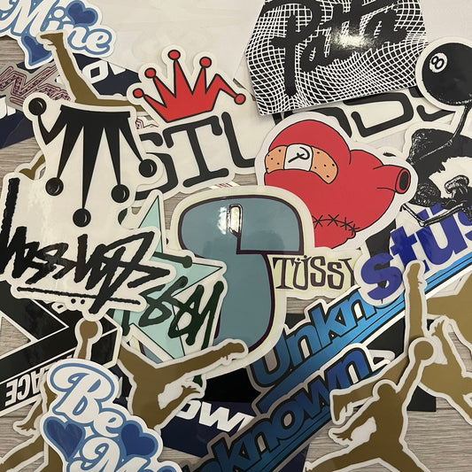 A collection of various stickers including brand logos and abstract designs.