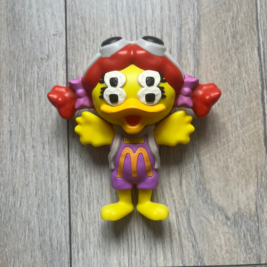 CPFM x McDonald's Birdie The Early Bird Figure from the 2022 collaboration between Cactus Plant Flea Market and McDonald’s. Features the signature yellow Bird character wearing a pruple and orange McDonald’s overalls ,with CPFM’s iconic four-eye design. Released as part of the adult Happy Meal collection in FW22, licensed on the back. Comes with the Foil bag.