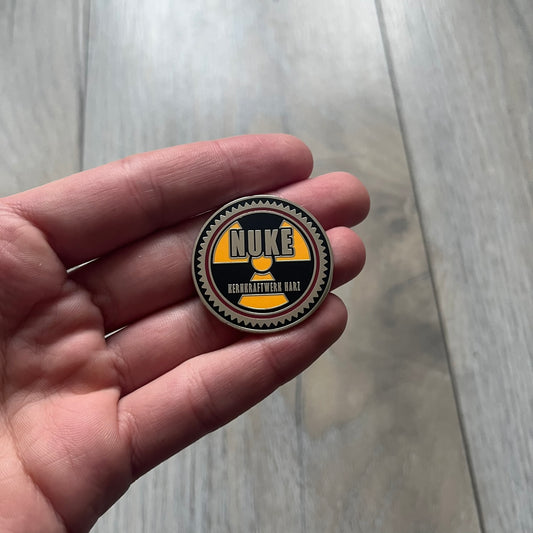 Original physical Counter-Strike: Global Offensive Series 1 Nuke pin, produced as official Valve merchandise. These pins were sold at Valve-sponsored CS:GO Major events and later via the official WeLoveFine store, and originally included a code to unlock a “Genuine” Nuke pin for the user’s Steam profile. This example comes with the original packaging; the code has been scratched (by me) but remains unused.