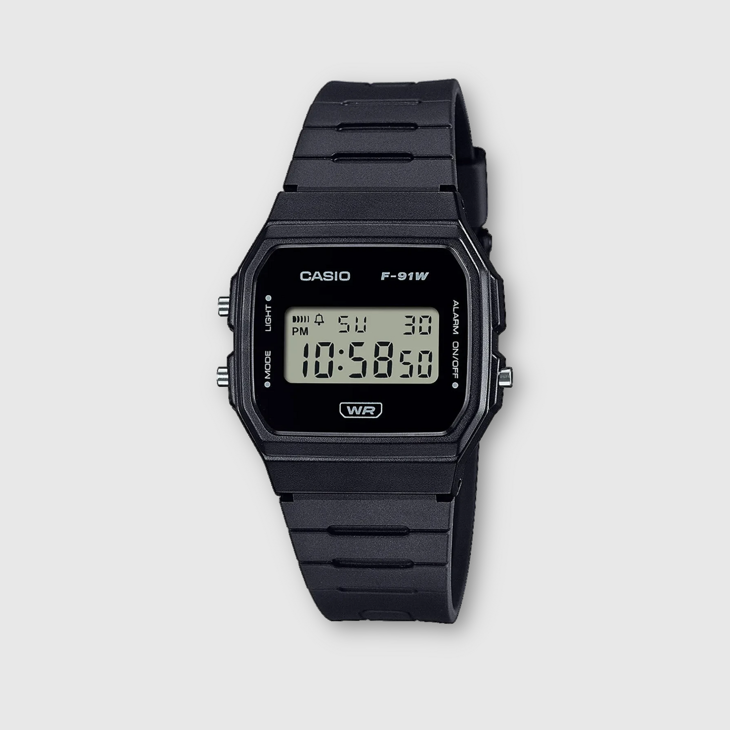 Black Casio digital watch on a light gray background