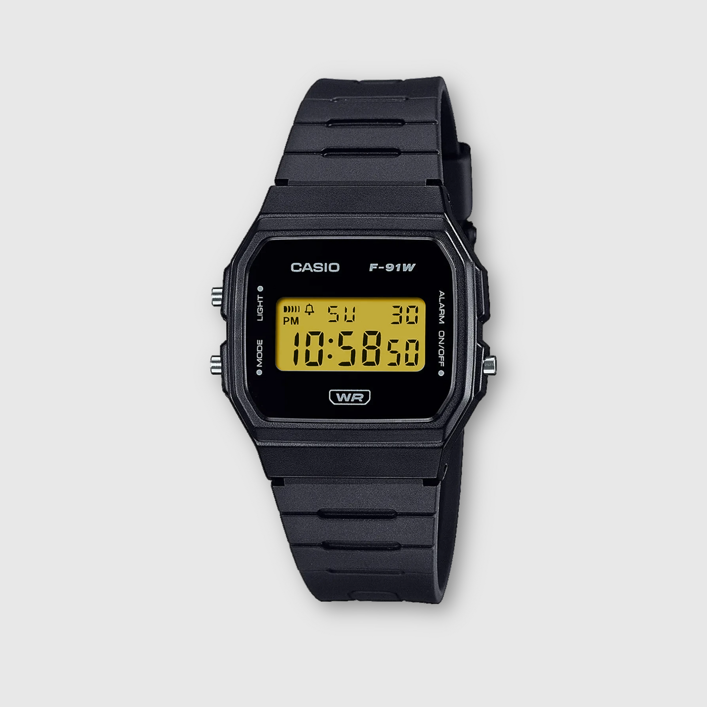 Black Casio digital watch on a light gray background