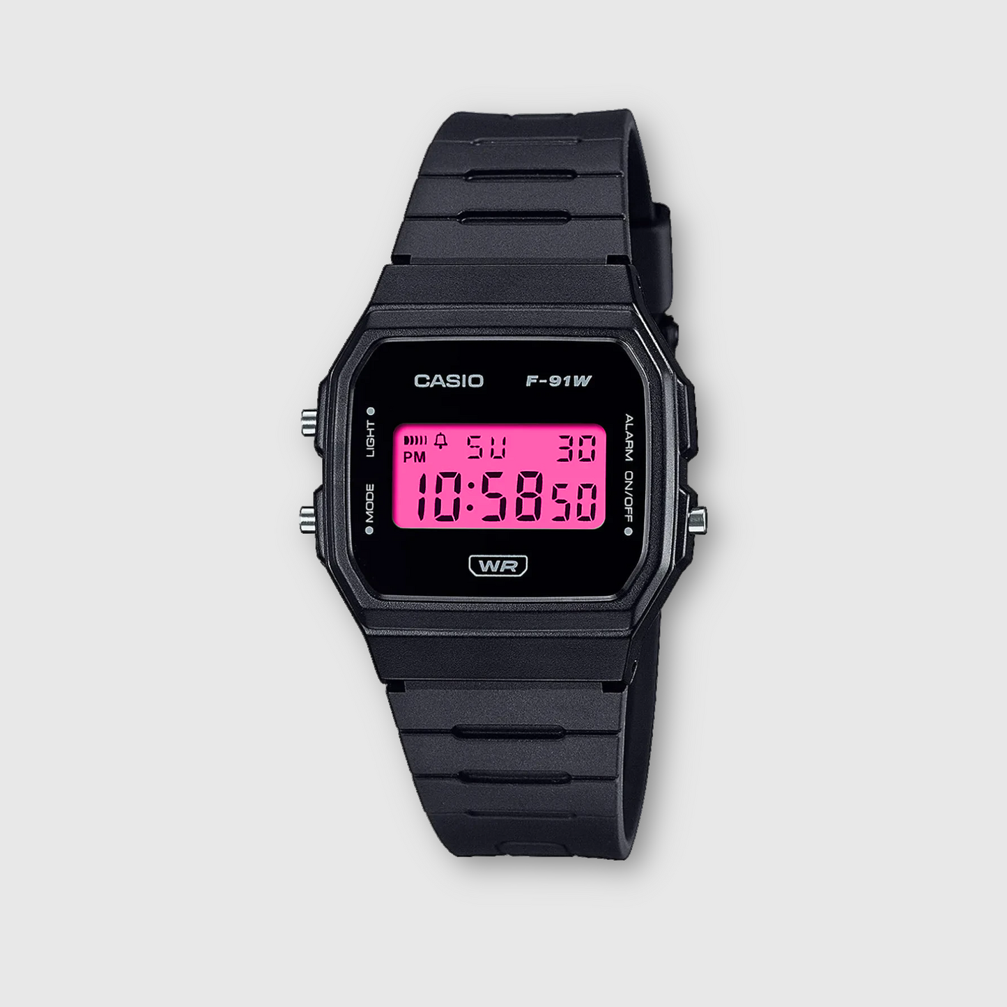 Black Casio digital watch with pink display on a light gray background