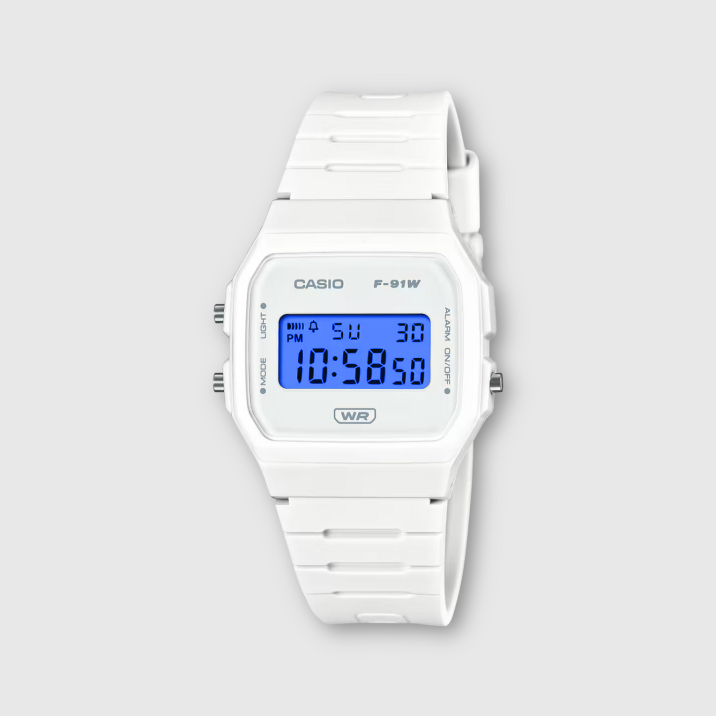 White Casio digital watch on a light gray background
