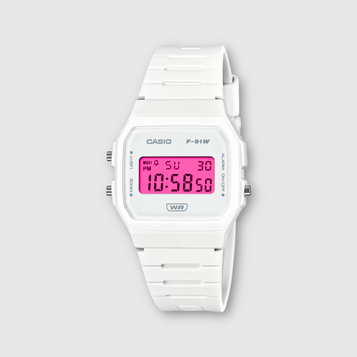 White Casio digital watch with pink display on a light gray background