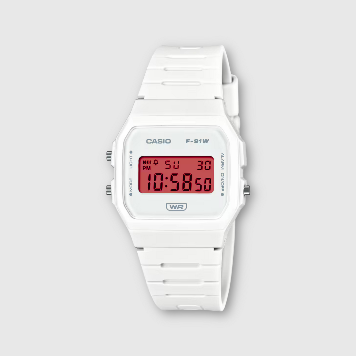 White Casio digital watch on a light gray background