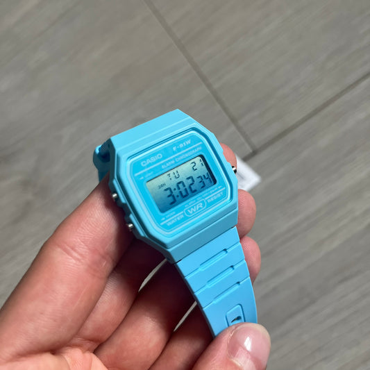 Custom Casio F-91W Baby Blue digital watch featuring a Gradient Blue filter screen. Slim 8.5 mm profile, lightweight 21 g build and flexible bio-based resin band ensure lasting comfort. Includes alarm, stopwatch, and microlight function for everyday functionality.