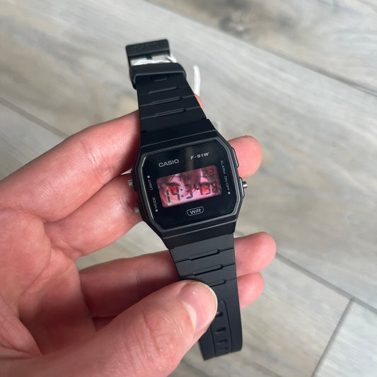Custom Casio F-91W Black digital watch featuring a Anime red eyes filter screen. Slim 8.5 mm profile, lightweight 21 g build and flexible bio-based resin band ensure lasting comfort. Includes alarm, stopwatch, and microlight function for everyday functionality.