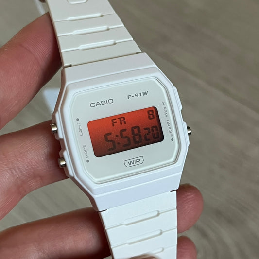 Custom Casio F-91W White digital watch featuring a Gradient Red filter screen. Slim 8.5 mm profile, lightweight 21 g build and flexible bio-based resin band ensure lasting comfort. Includes alarm, stopwatch, and microlight function for everyday functionality.