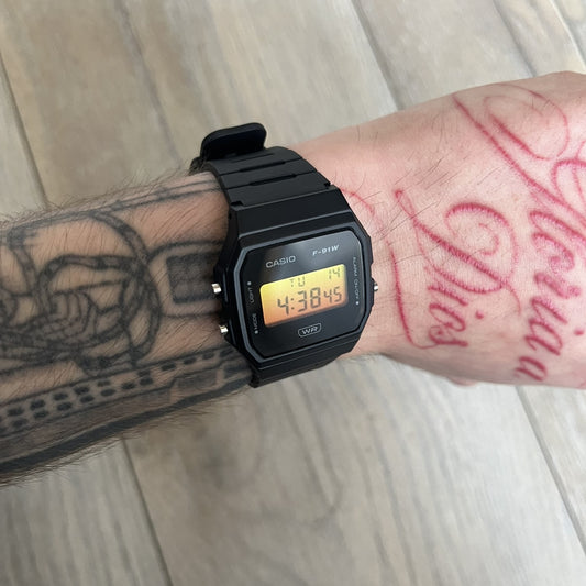 Custom Casio F-91W Black digital watch featuring a Gradient Yellow & Orange filter screen. Slim 8.5 mm profile, lightweight 21 g build and flexible bio-based resin band ensure lasting comfort. Includes alarm, stopwatch, and microlight function for everyday functionality.