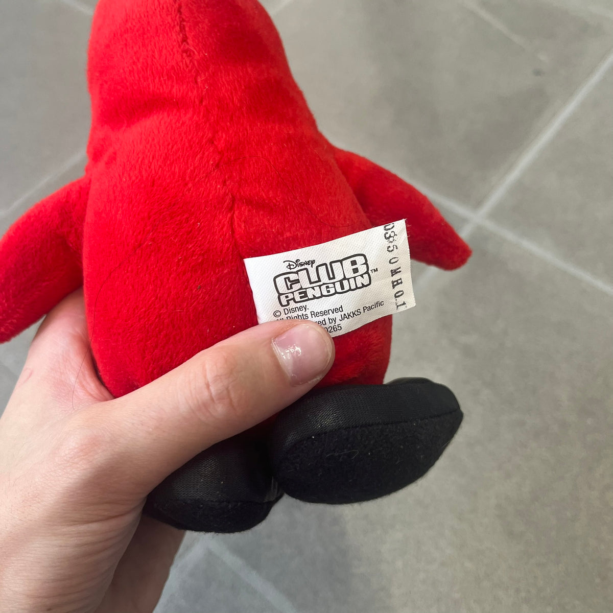 Club Penguin 2010 Series 7 Secret Agent Penguin Plushie is a red penguin with black sunglasses on. He originally had a tuxedo. Released in 2010 by Disney and Jakks Pacific, featuring an embroidered Club Penguin logo on the bottom of the foot. It comes with a Disney-licensed tag.