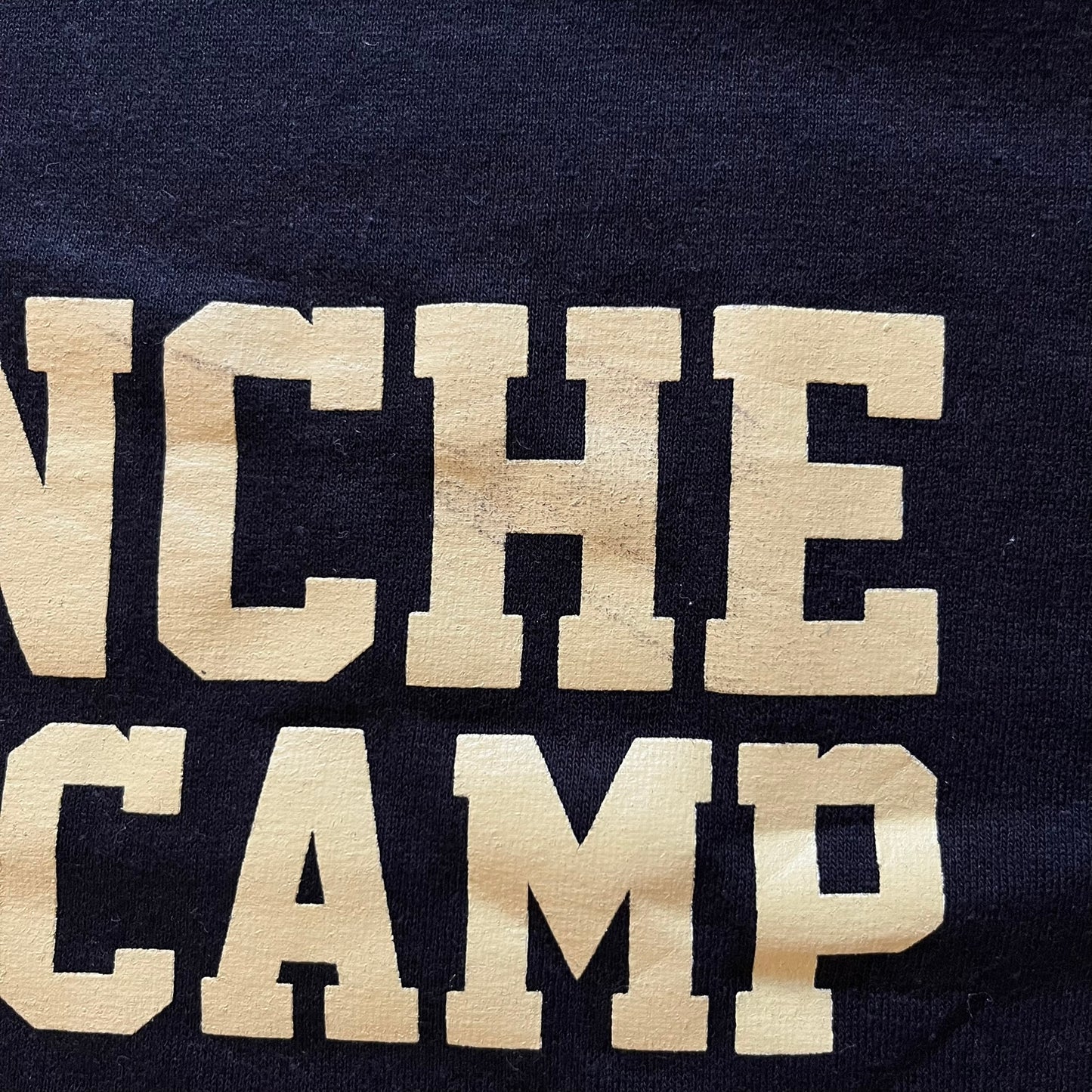 Text 'NCHEN CAMP' on a dark background