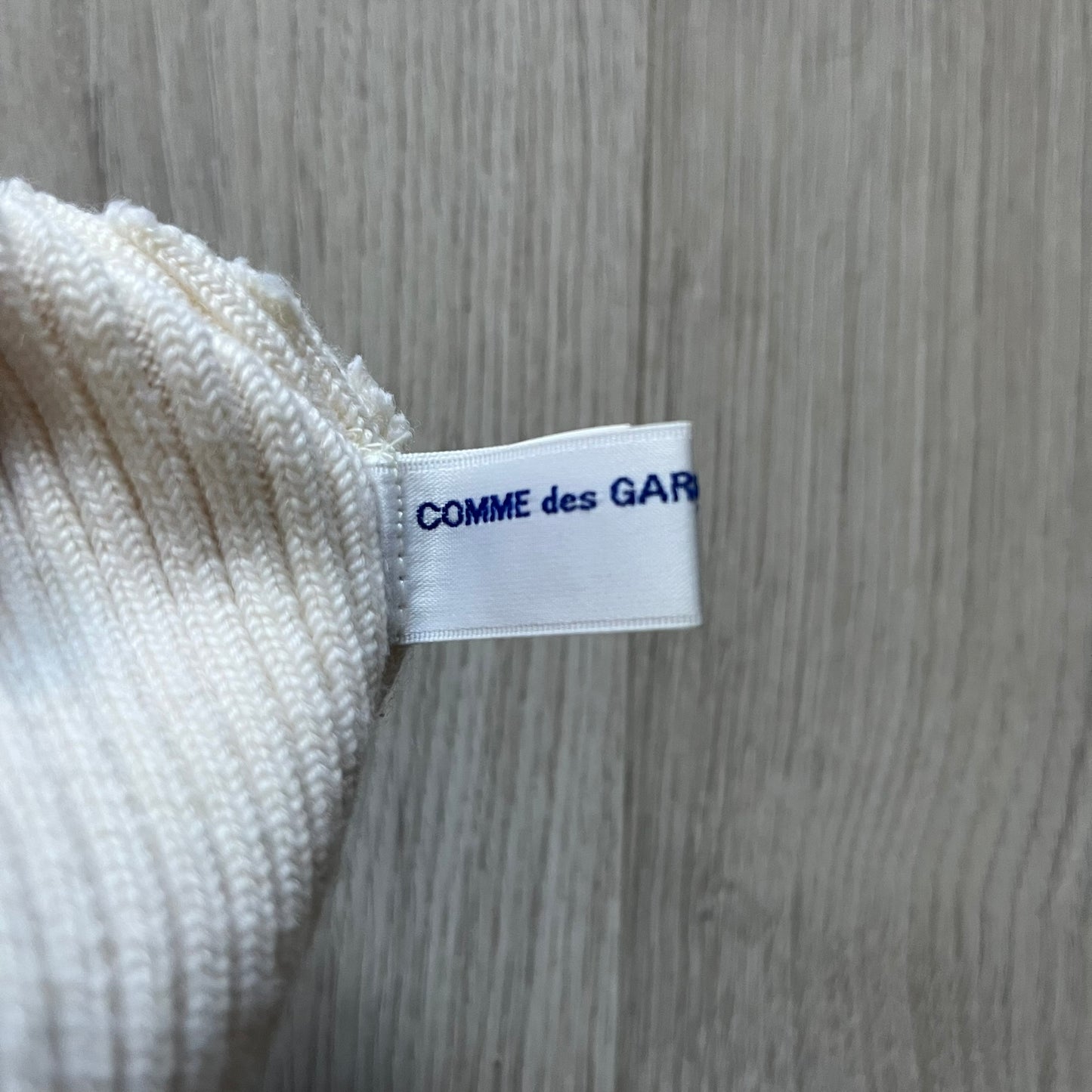 Released in Autumn/Winter 2018, this Comme des Garçons beanie playfully reimagines the classic knit hat with ‘Mickey Mouse’-inspired ears. Crafted in an off-white shade with ribbed detailing, it balances fun design with signature CDG avant-garde flair. A standout seasonal accessory with a collectible edge.