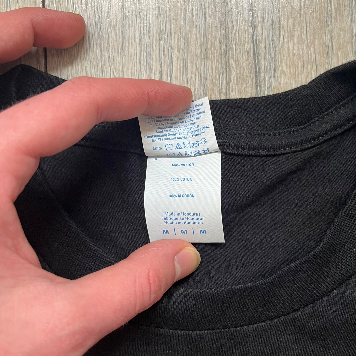 Dexter “Blood Never Lies” 2017 Tee is a black T-shirt featuring a front graphic with red blood-style “Dexter” and “Blood Never Lies” text. Between the texts, the print shows blood-covered tools with Dexter visible in the reflection of a saw. Small 2017 Showtime licensing text appears beneath the graphic, confirming official series merchandise.