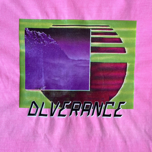Diesel DLVERANCE Bright Pink Tee features a 100% cotton jersey construction with a fluorescent pink pigment-dyed finish. The front has a rubberised “DLVERANCE” graphic, with a small rubber “Copyright” logo on the lower back.