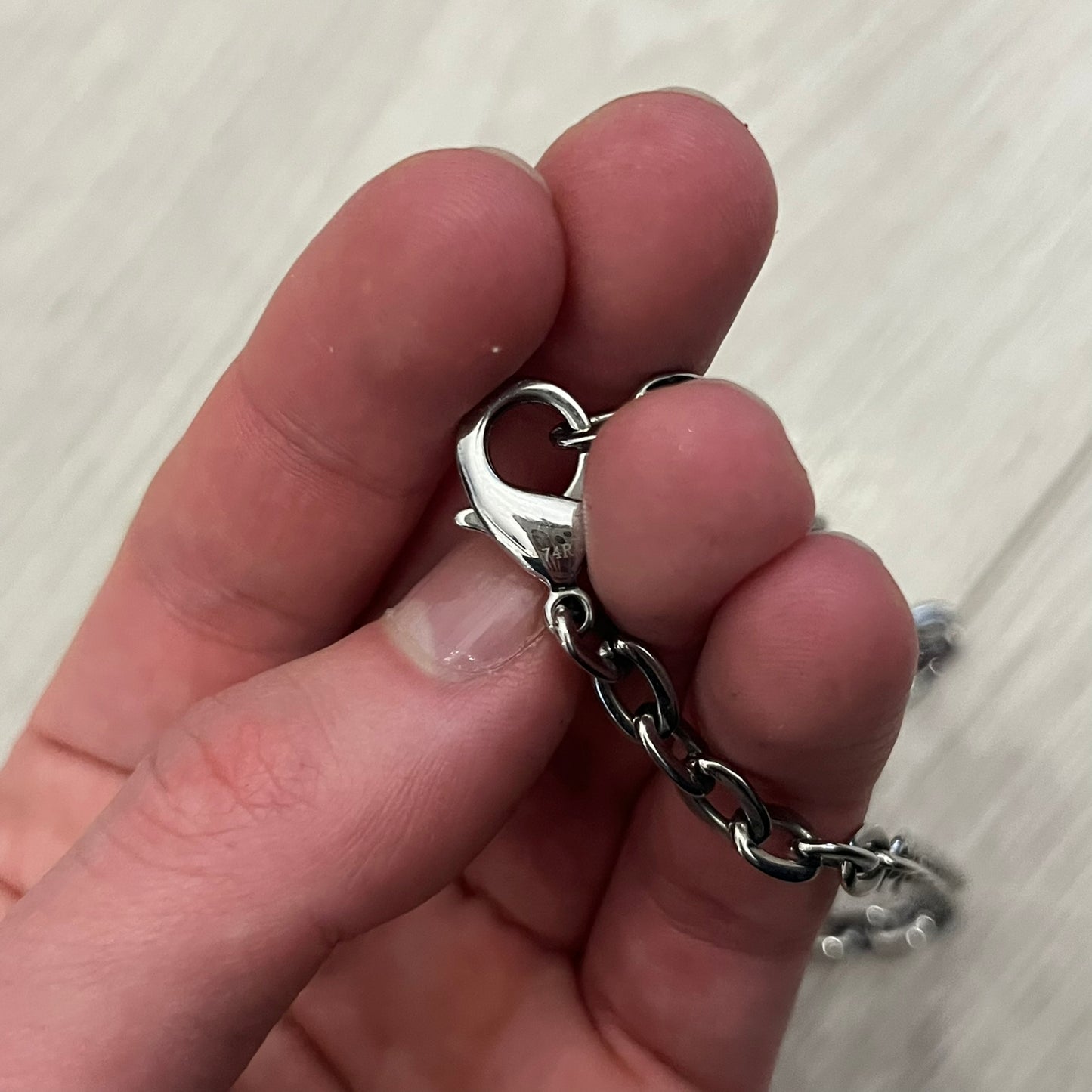 Dolce & Gabbana Propaganda Dog Tag Necklace, featuring a silver stainless steel square tag with four visible screws and the D&G logo engraved on the front. The tag hangs from a durable cable chain, combining sturdy construction with clean, industrial-inspired detailing.