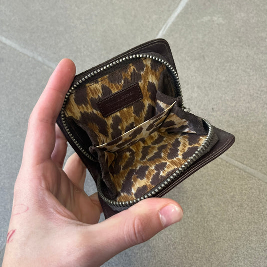 Dolce & Gabbana 2000's Leather Chain Wallet is made in Italy from a combination of suede and shiny leather, featuring two visible screw details and a D&G logo on the leather portion. The interior includes two pockets and a leather tag, with an attached chain.