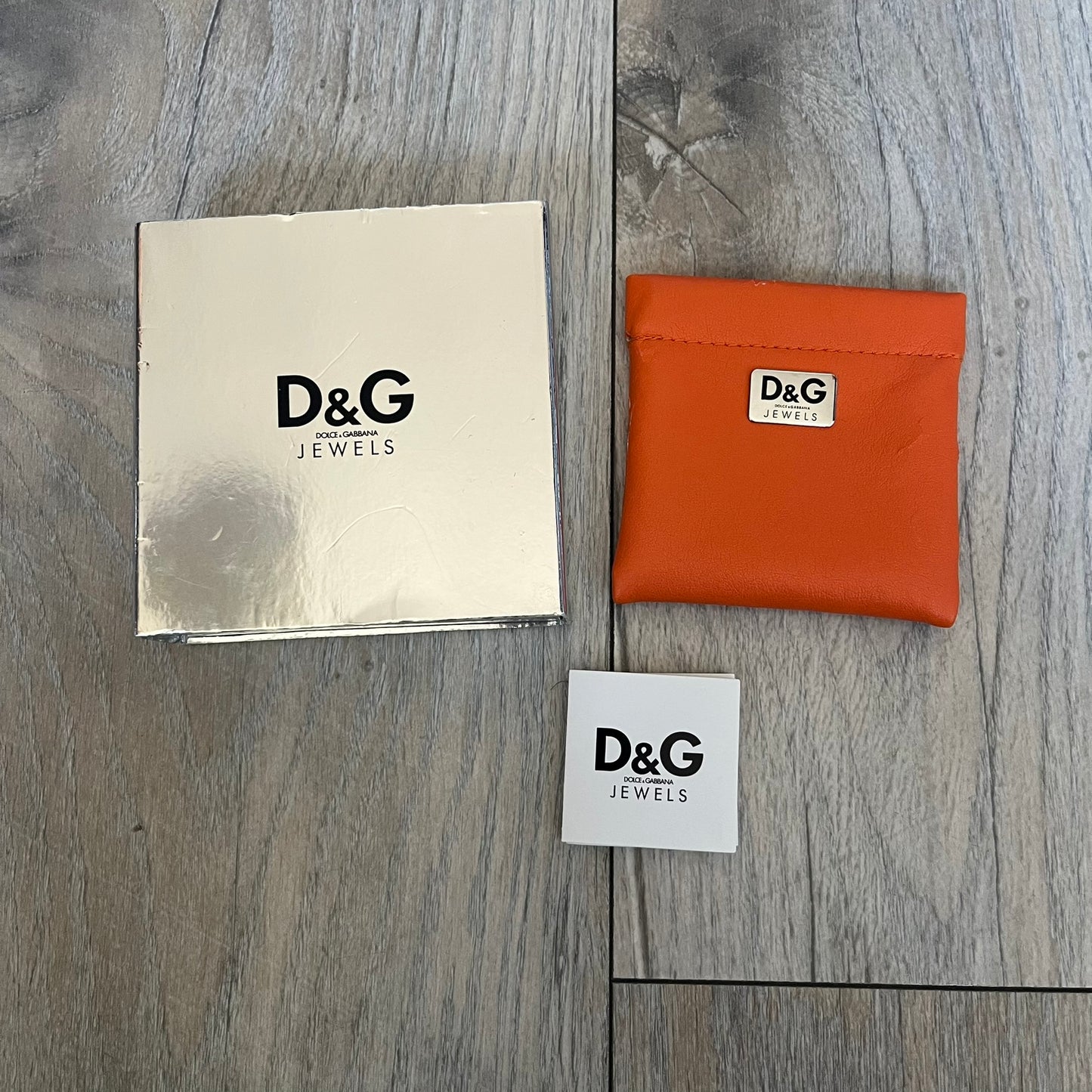 Dolce & Gabbana plain logo dog tag necklace in silver-tone stainless steel, featuring the iconic D&G logo engraved on a sleek tag. Suspended on a classic ball chain with a regulated size. A versatile accessory that combines minimal branding with everyday wearability.