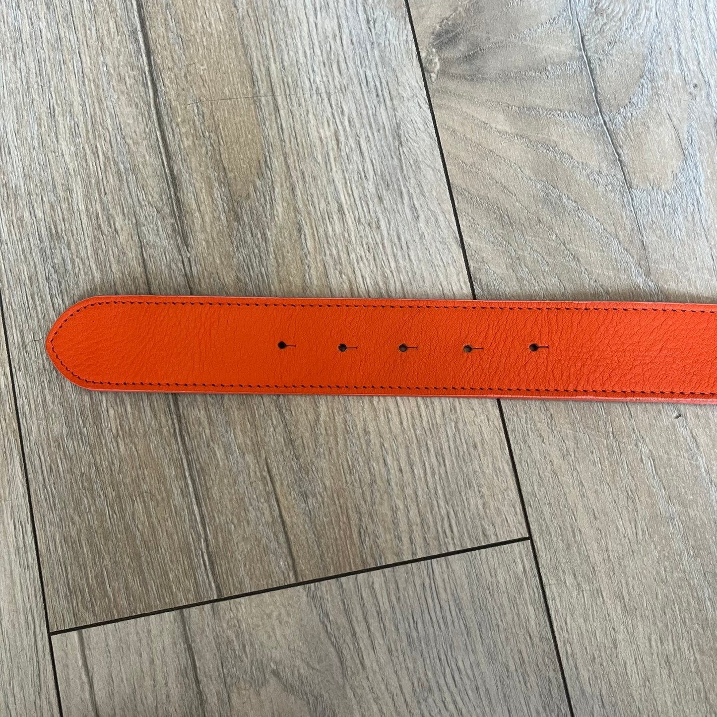 Dolce & Gabbana 2008 Butterfly Buckle Orange Leather Belt from the AW2008 collection. Crafted from smooth orange leather with visible edge stitching, this belt features a big silver-tone D&G logo buckle shaped in a butterfly-style form. The buckle has a polished metal finish, while the belt itself is made from 100% leather and retains a clean, structured profile. An original seasonal accessory from Dolce & Gabbana’s AW2008 season.