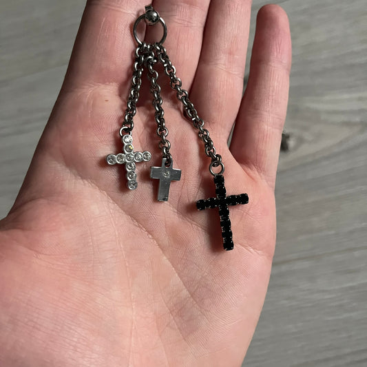 Dolce & Gabbana Dangle Drop Cross Earrings. Pair of earrings featuring three crosses of varying lengths on each, including one with black stones, one with clear stones, and one full metal cross with a D&G logo and a small clear stone. Comes with original box and dustbag