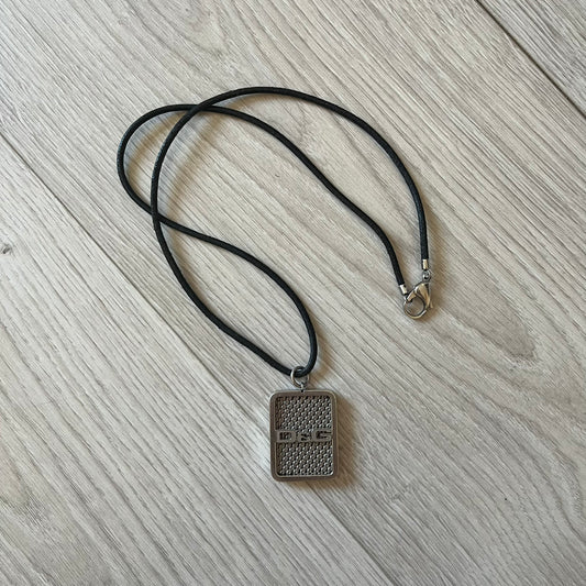 Necklace with a rectangular pendant on a wooden surface