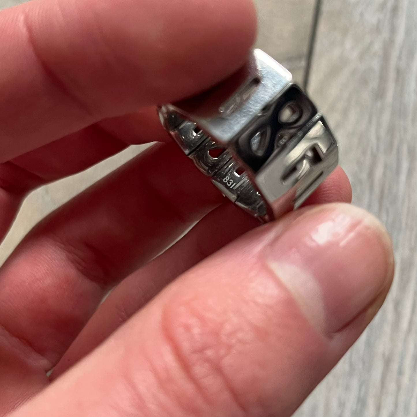 Dolce & Gabbana Overlap DJ0538 Ring is a stainless steel ring constructed entirely from cutout D&G letters. The design features 12 letters forming 4 repeating D&G sets, with each letter’s inner spaces incorporated into the openwork structure