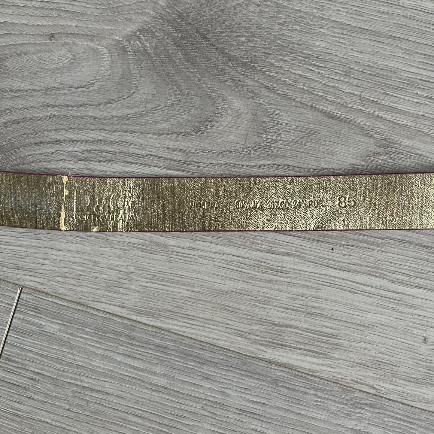This Dolce & Gabbana Belt combines a slim pink design with a statement D&G buckle framed in gold and accented by visible screws. The inner side of the belt features a gold finish, highlighting the brand’s attention to material contrast. A classic Italian accessory crafted with detailed hardware.