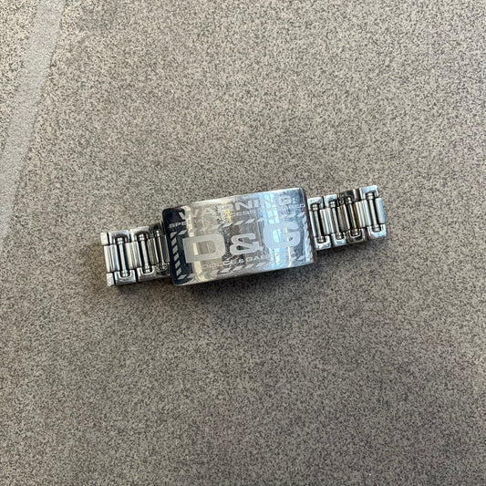 Dolce & Gabbana Warning Stainless Steel Bracelet. From the Spring/Summer 2006 collection, this bracelet features a polished stainless steel design with a clip closure. The front plate displays “Warning Special Access Required” alongside D&G Dolce & Gabbana branding.