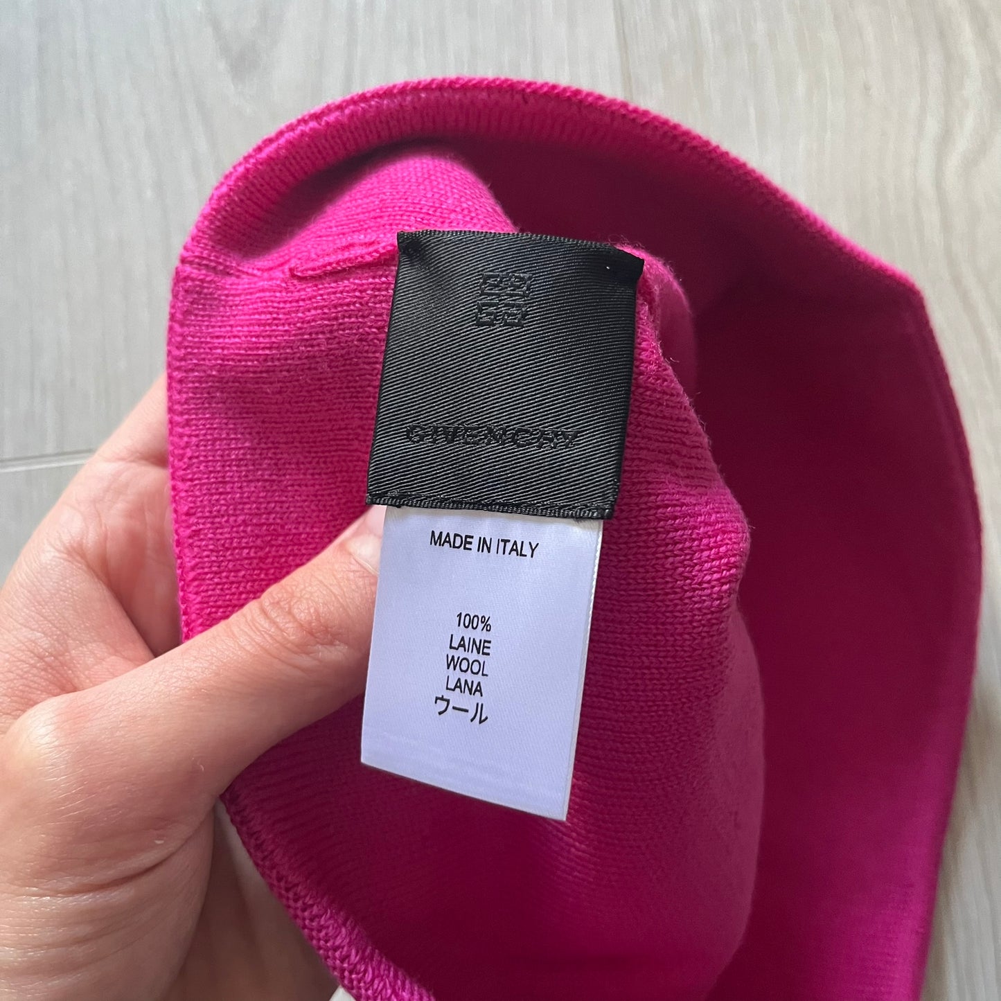 Pink Givenchy Jacquard beanie made from 100% wool and crafted in Italy. Features the black contrasting logo around the rolled brim, splitting “GIVE” and “NCHY” across the hem. Premium construction with a soft, comfortable fit.