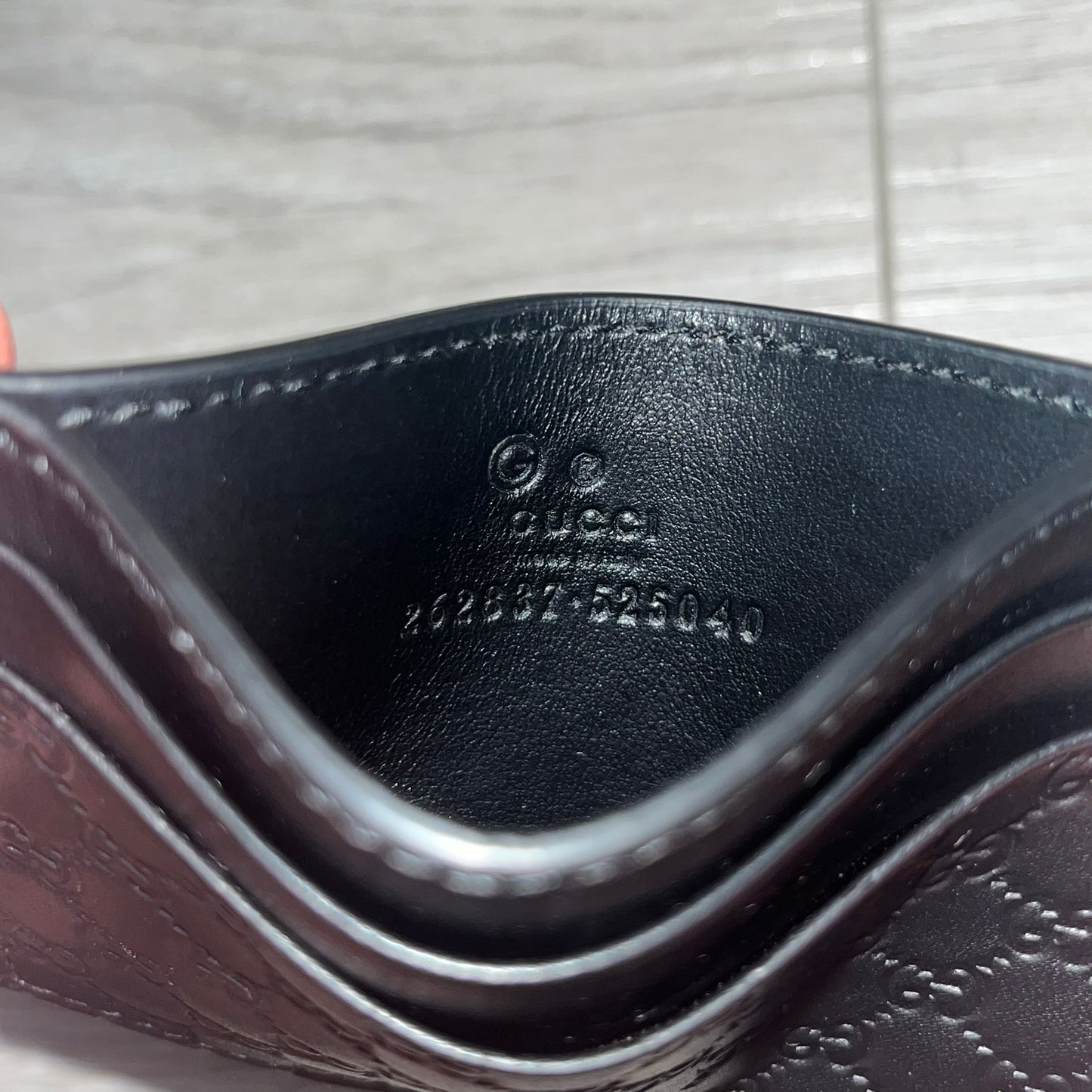 Gucci Microguccissima Black Cardholder crafted in Italy from premium black calf leather with the iconic Microguccissima pattern. Features five card slots, including a central compartment for bills or additional cards. Compact and refined, this Gucci leather card case combines durability with timeless design.