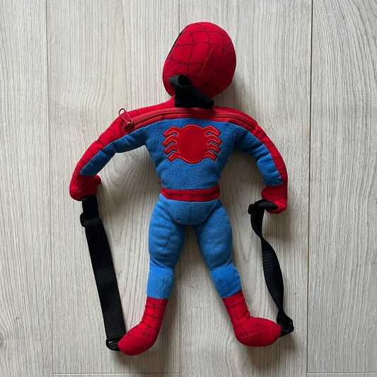 2006 H&M x Marvel Spider-Man Backpack shaped as Spider-Man in his signature red and blue outfit. Features a compact back pocket and unique strap placement connecting his hands to his legs. Rare early 2000s collaboration collectible.