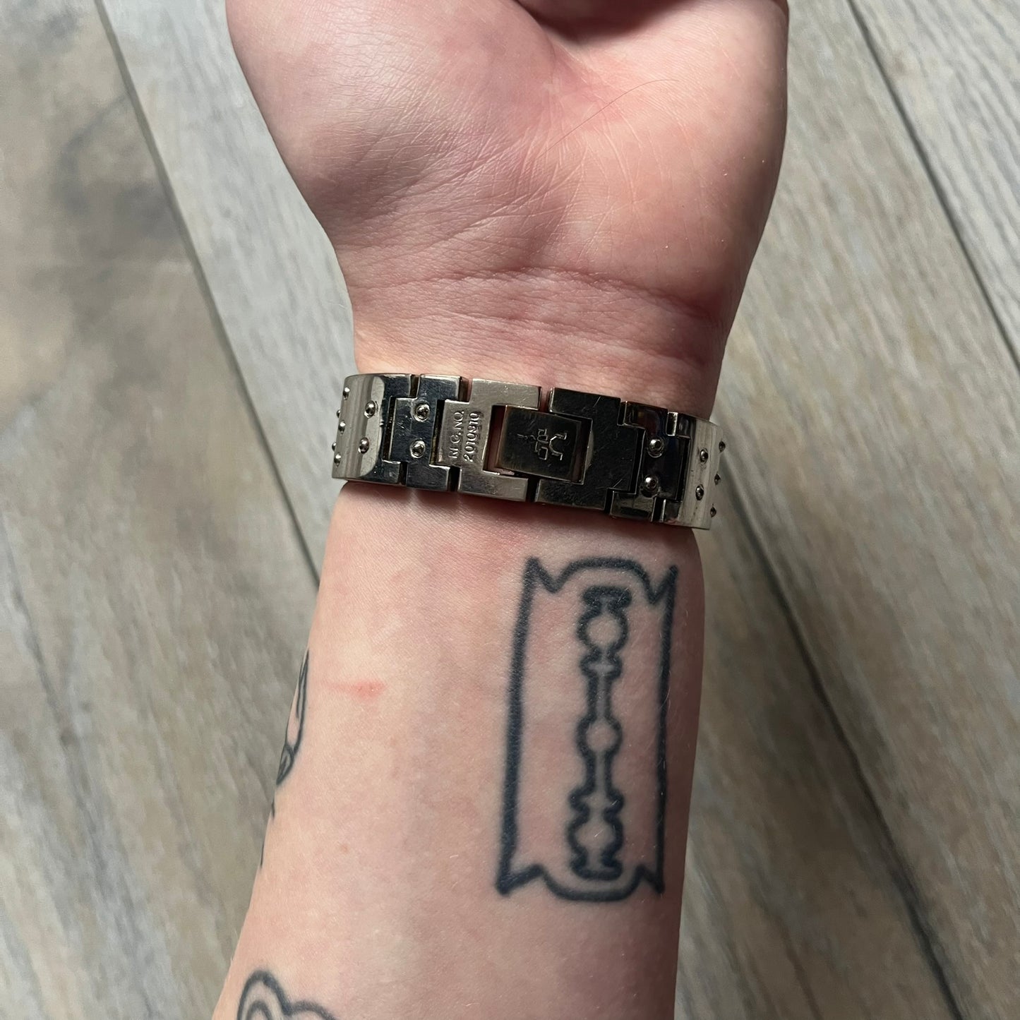 Hi-Tek Alexander “Cylinder” 90’s Analog Watch is a 1990s English-made timepiece featuring a black dial with a small Hi-Tek logo as the seconds hand. The cylindrical 3D case rises from the wrist, making the dial visible only from above, and the straps feature raised dot detailing. The stainless steel case back is branded with the Hi-Tek logo, designed specifically for smaller wrists.