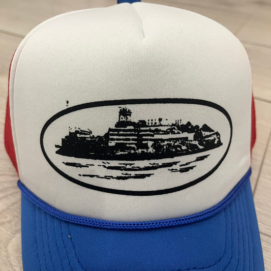 corteiz alcatraz trucker hat white blue red
