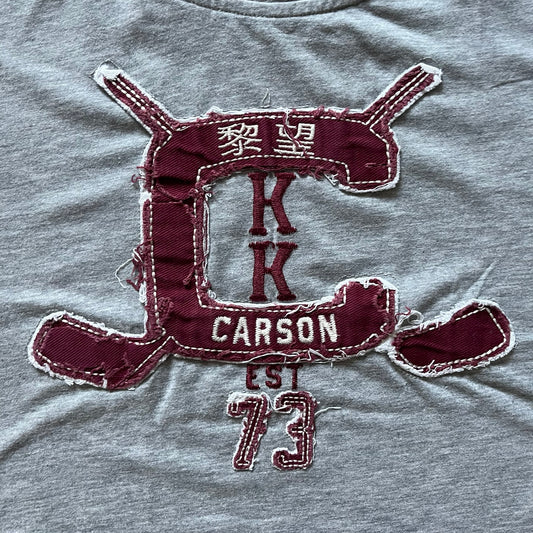 Maroon patch with 'Carrson' text on a gray fabric background