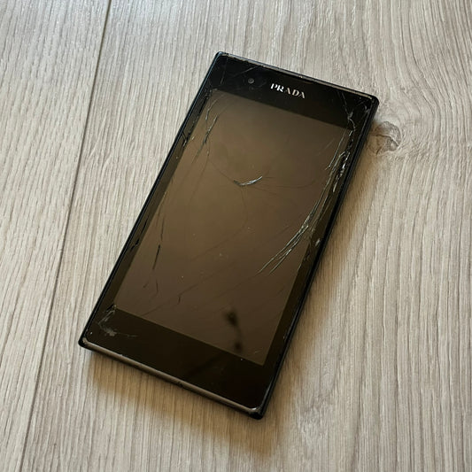 Non-functional LG Prada 3.0 P940 with cracked display, perfect for repair or as a display item. This model represents the last collaboration between LG and Prada, combining luxury design with early 2010s smartphone tech. A rare find despite its condition.