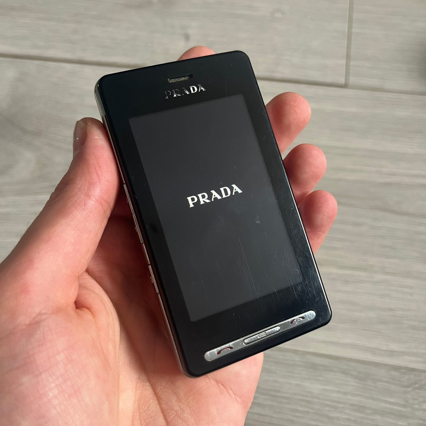 The LG Prada KE850, a groundbreaking collaboration between LG and Prada marked the world’s first capacitive touchscreen phone. Finished in sleek black with minimalist Prada aesthetics, it features media playback, Bluetooth, and expandable memory. Includes the full original Prada set: box, charger, cable, music device, manuals, and CD. Unlocked and functional for basic functions; for calling and texting you need your own SIM card.