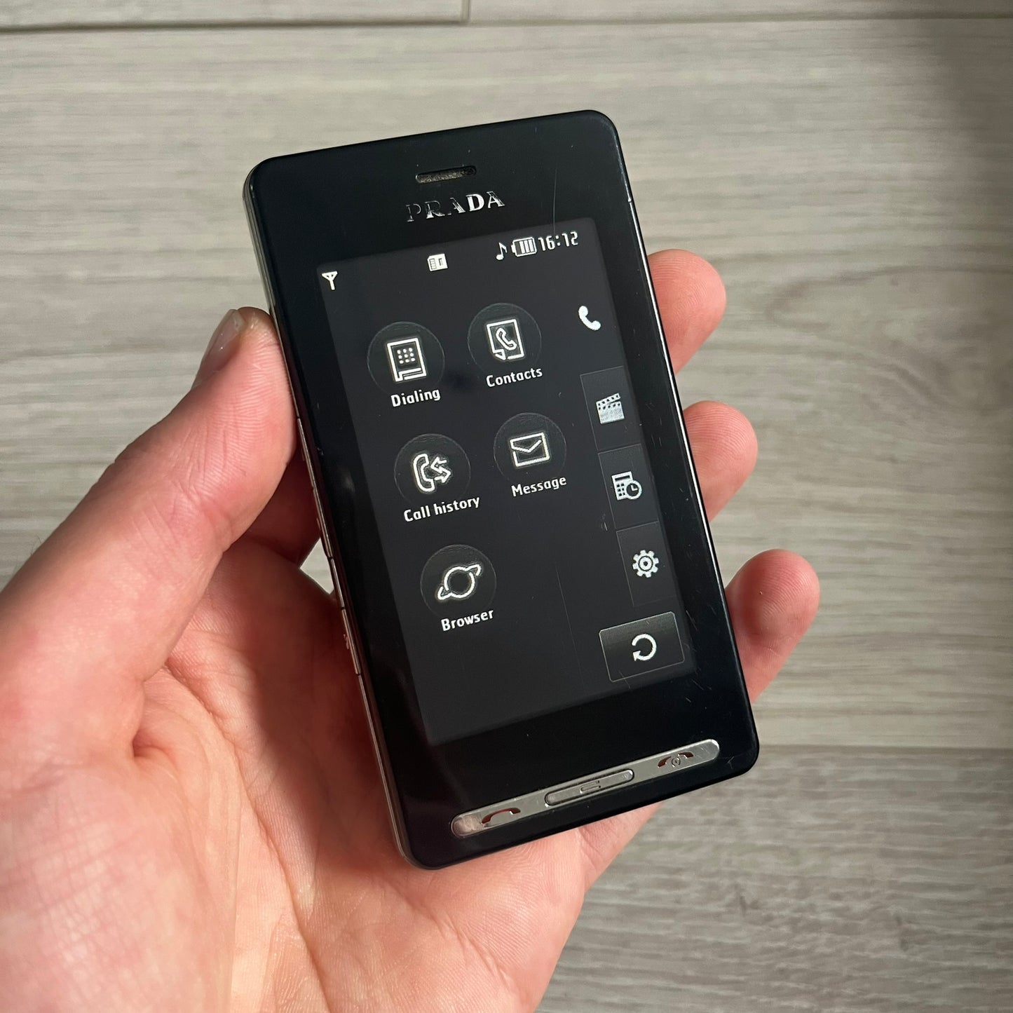 The LG Prada KE850, a groundbreaking collaboration between LG and Prada marked the world’s first capacitive touchscreen phone. Finished in sleek black with minimalist Prada aesthetics, it features media playback, Bluetooth, and expandable memory. Includes the full original Prada set: box, charger, cable, music device, manuals, and CD. Unlocked and functional for basic functions; for calling and texting you need your own SIM card.