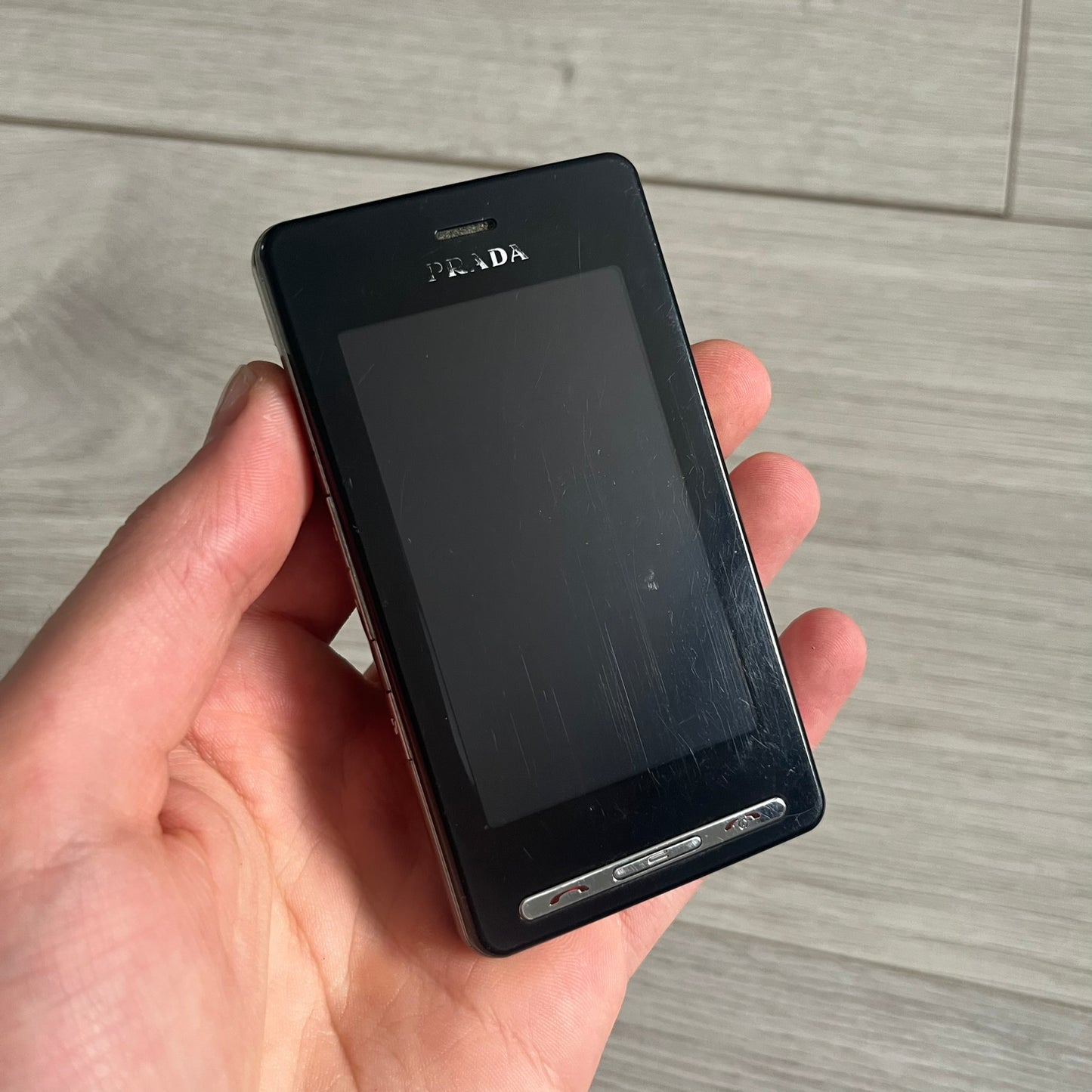 The LG Prada KE850, a groundbreaking collaboration between LG and Prada marked the world’s first capacitive touchscreen phone. Finished in sleek black with minimalist Prada aesthetics, it features media playback, Bluetooth, and expandable memory. Includes the full original Prada set: box, charger, cable, music device, manuals, and CD. Unlocked and functional for basic functions; for calling and texting you need your own SIM card.