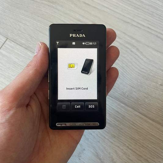 LG Prada KE850 touchscreen phone, the first of its kind with a capacitive display, designed in collaboration with Prada. Sleek black minimalist design, pre-loaded games, PDF and Office support, Bluetooth, and expandable memory. Comes complete with Prada box and leather etui - a collectible milestone in mobile fashion history.