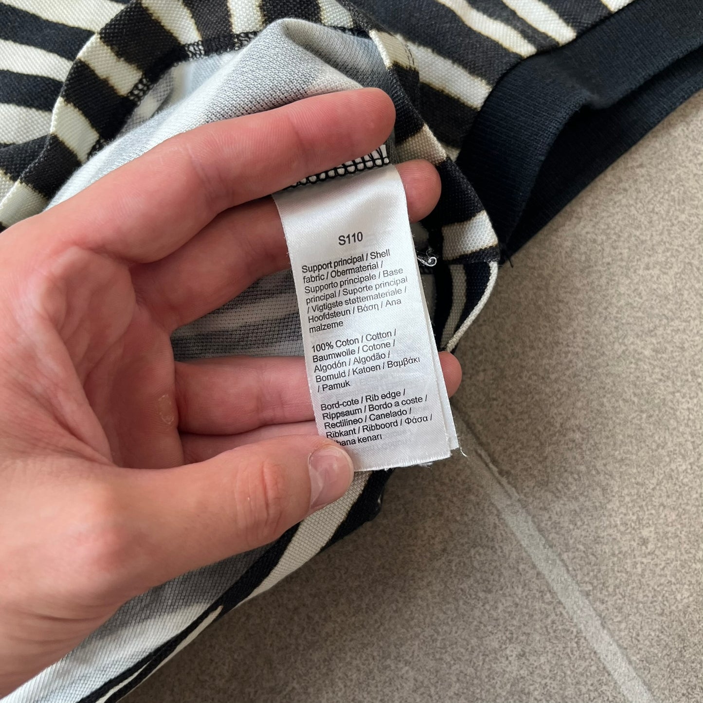 Lacoste x National Geographic AW20 Zebra Polo features an all-over white and black zebra print pattern across the fabric. The polo has black collar and sleeve hems, with a chest patch featuring the Lacoste crocodile logo in matching pattern colors.